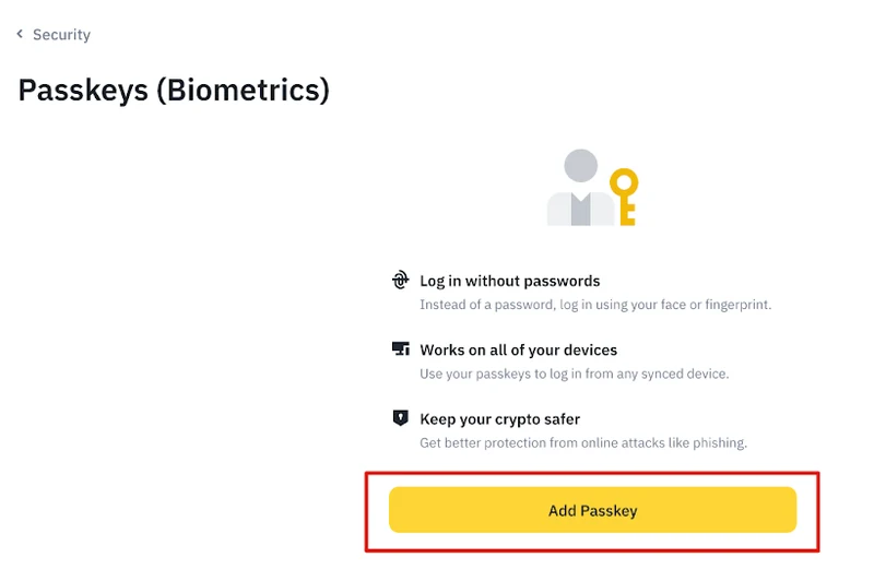 幣安網站版「Passkeys (Biometrics)」頁面，左上為返回 Security 的連結，頁面中央列出 Log in without passwords、Works on all of your devices、Keep your crypto safer 三項說明，下方是以紅框標示的 Add Passkey 按鈕